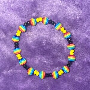 Multi color acrylic beads , with pink and black beads .